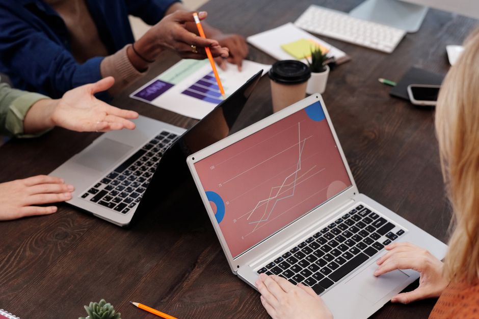 Group of professionals discussing data analytics in a modern office setting.